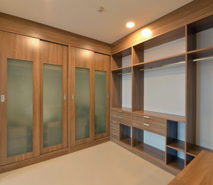 wooden carbinets in dressing room in modern home, interior design